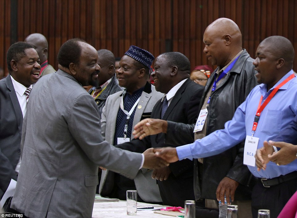 Also at the meeting (delegates greeting one another pictured above), Mugabe's  hated wife, 'Gucci' Grace, was expelled from her role as head of the Zanu-PF Women's League