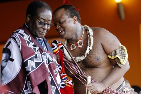 What could he be saying? Swaziland King Mswati chats with President Mugabe during Swaziland's Reed dance where unmarried and childless Swazi girls and women travel from the various chiefdoms to the Ludzidzini Royal Village to participate in the eight-day event.
