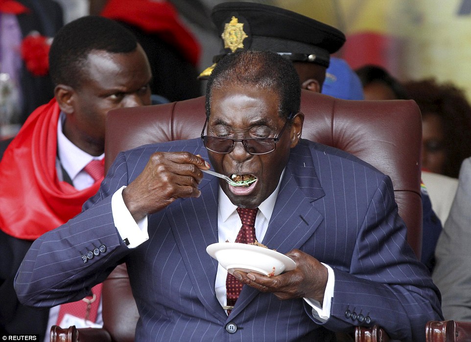 Zimbabwe's President Robert Mugabe eats some cake at his 92nd birthday celebration in Masvingo, Zimbabwe, on February 27. PHILIMON BULAWAYO/REUTERS