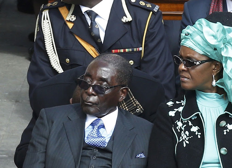 Zimbabwe's President Robert Mugabe and his wife Grace (R) attend the inaugural mass of Pope Francis at the Vatican, March 19, 2013. Pope Francis celebrates his inaugural mass on Tuesday among political and religious leaders from around the world and amid a wave of hope for a renewal of the scandal-plagued Roman Catholic Church. REUTERS/Stefano Rellandini (VATICAN - Tags: RELIGION POLITICS)