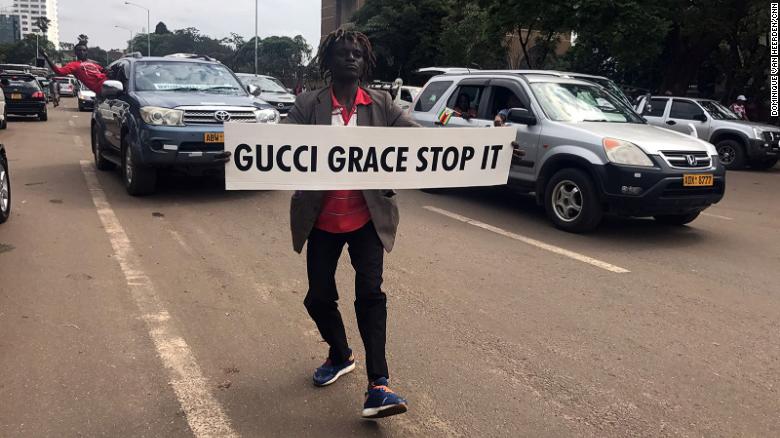 A demonstrator carries a sign directed at first lady Grace Mugabe.