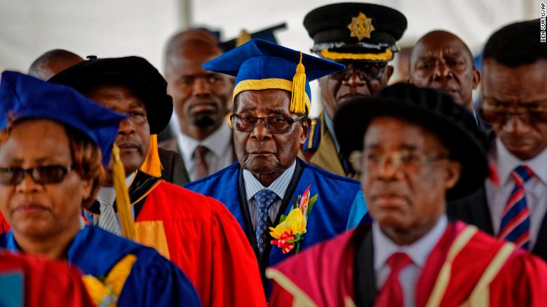 Mugabe, center, presides over a student graduation ceremony at Zimbabwe Open University on Friday.