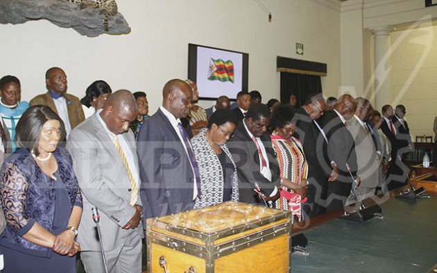 Ministers and members of parliament from Zanu Pf praying before a motion to impeach President Mugabe. Picture by John Manzongo