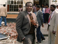 1986: Mugabe leaves the scene of the African National Congress (ANC) offices that were bombed days earlier by a South African commando