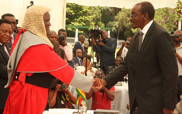 Chief Justice Luke Malaba swears in Vice President Kembo Dugish Campbell Mohadi at State House in Harare yesterday.-(Picture by Tawanda Mudimu)