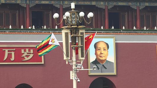 Chinese and Zimbabwean national flags in front of the Tian'anmen Rostrum on April 3, 2018, in Beijing, China.