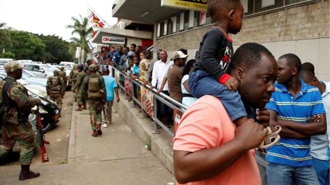 People queue at a supermarket in Harare on Wednesday