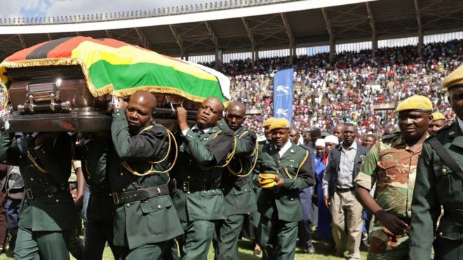 Pallbearers carry the coffin of the late Zimbabwean jazz and afro pop musician Oliver Mtukudzi as it departs at the National Sports Stadium in Harare,