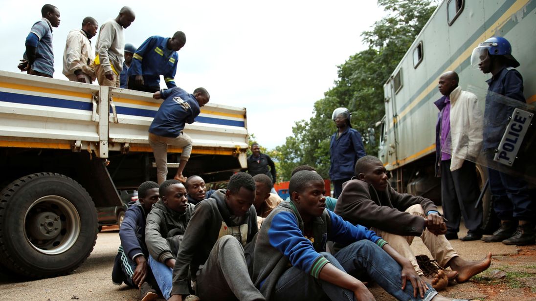 People arrested during protests wait to appear at magistrates' court in Harare