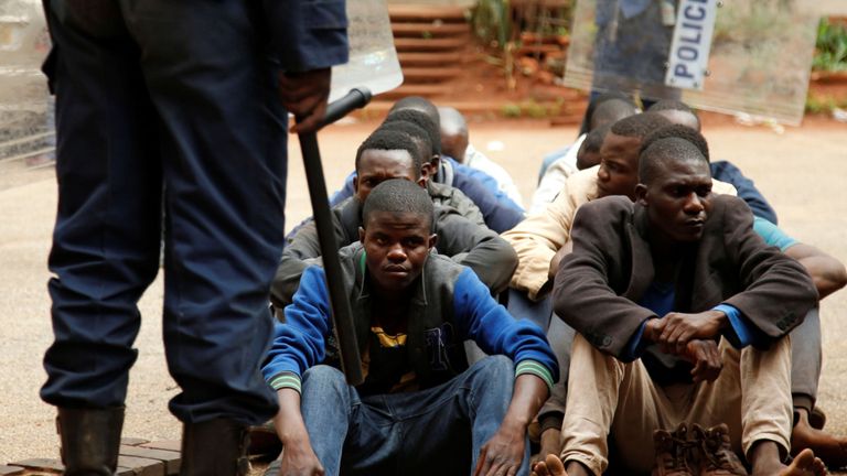 People arrested during protests wait to appear at a magistrates' court in Harare