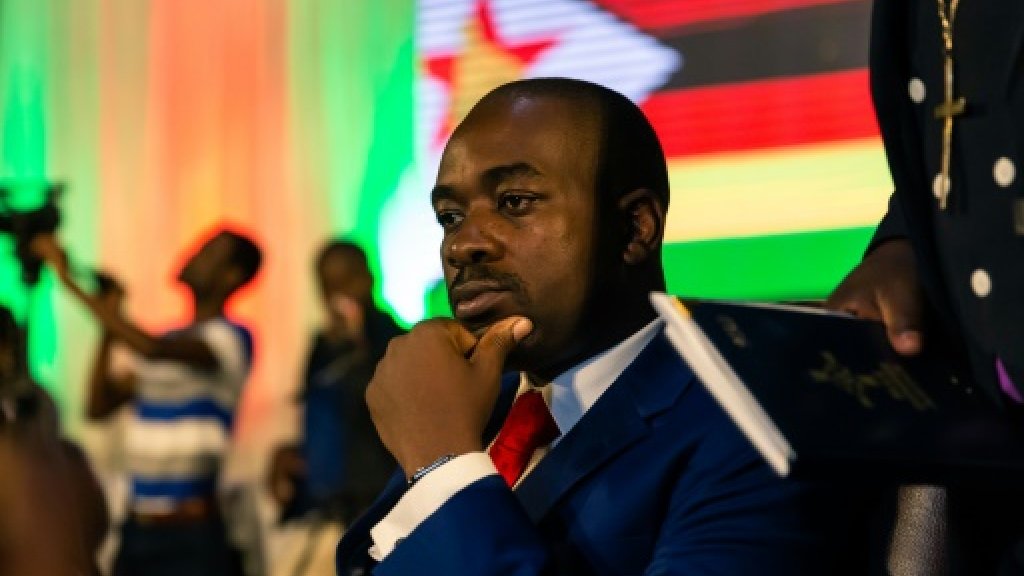 Zimbabwean opposition leader Nelson Chamisa of the MDC Alliance listens to participants during a prayer as part of a meeting organized by a coalition of Christian churches to facilitate dialogue between political party leaders,