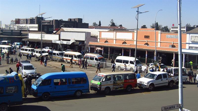 Buses in Harare queue to fill up with diesel, before fuel prices in Zimbabwe rise again [Chris Murzoni/Al Jazeera]