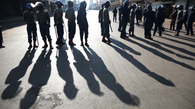 Members of the Zimbabwe Republic Police block the road to contain the planned Movement For Democratic Change Alliance Peace March in Harare. Photograph: Aaron Ufumeli/EPA