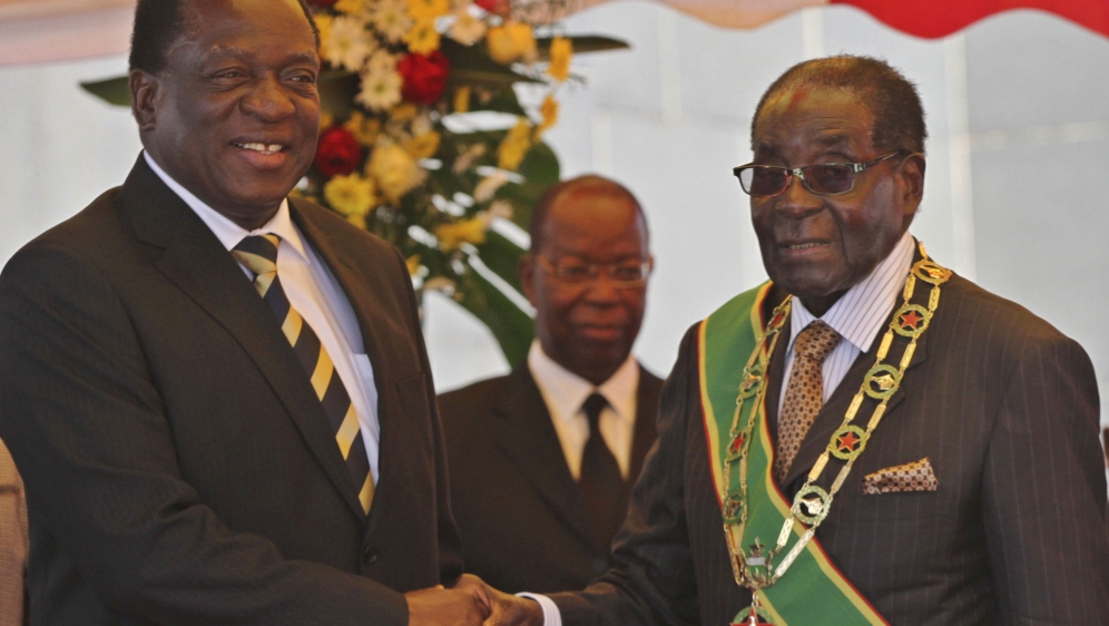 President Robert Mugabe (R) greets Vice President Emmerson Mnangagwa as he arrives for Zimbabwe's Heroes Day commemorations in Harare, August 10, 2015. REUTERS/Philimon Bulawayo President Mugabe greets Vice President Mnangagwa as he arrives for Zimbabwe's Heroes Day commemorations in Harare