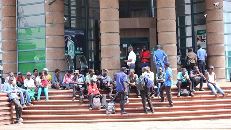 Zimbabwe's central bank chief said the new Zimbabwean dollar should help alleviate the need for people to queue outside of banks to get their hands on hard currency [Chris Muronzi/Al Jazeera]