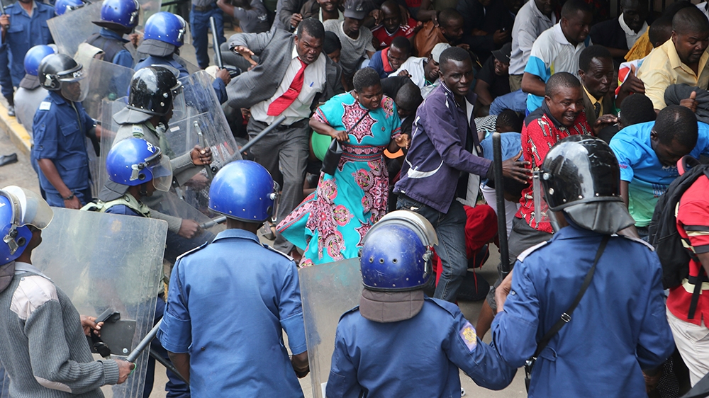 Police surround and assault opposition party supporters who had gathered to hear a speech by the countrys top opposition leader in Harare, Wednesday, Nov, 20, 2019. Zimbabwean police with riot g