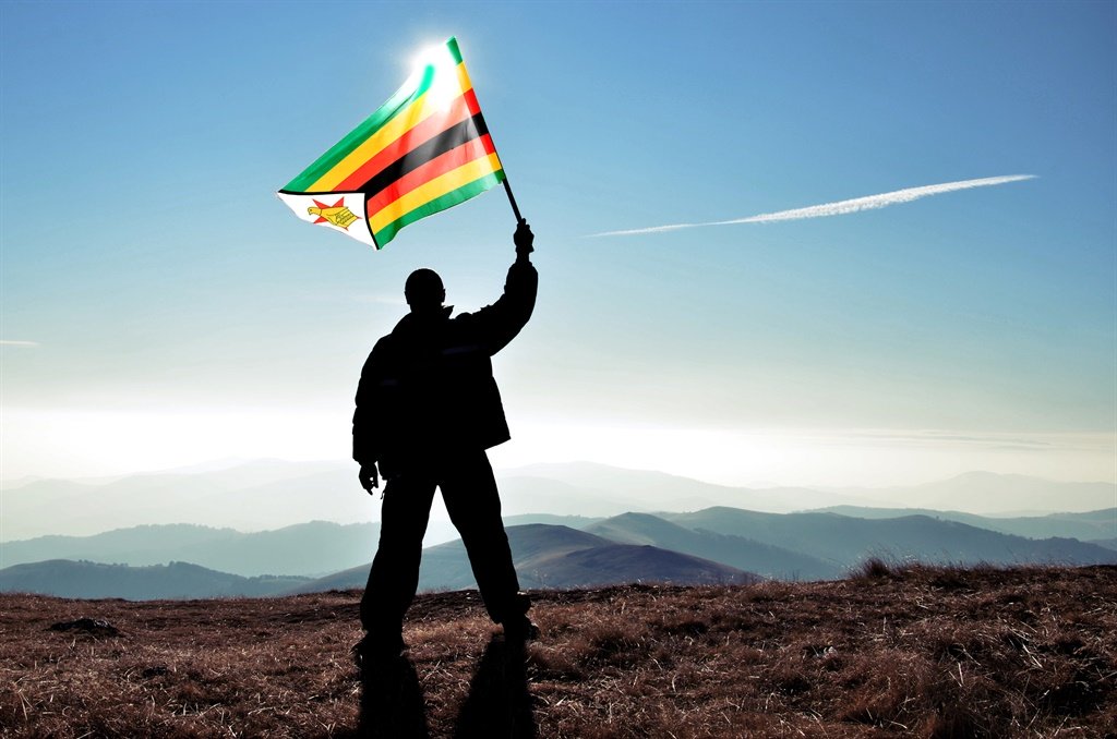 Successful silhouette man winner waving Zimbabwe f