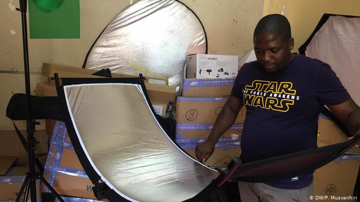 A man holding a reflector (DW/P. Musvanhiri)