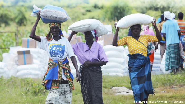 Women carry bags of corn they received as food aid, in Mudzi about 230 Kilometers northeast of the Zimbabwean capital Harare Women carry bags of corn they received as food aid, in Mudzi about 230 Kilometers northeast of the Zimbabwean capital Harare