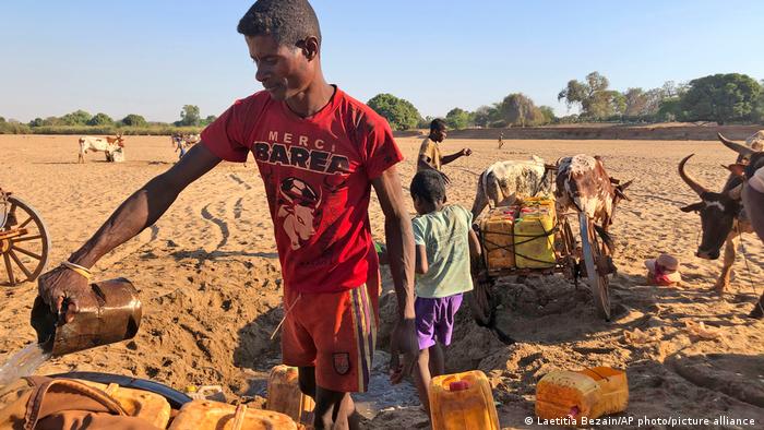 Men dig for water in the dry Mandrare river bed, in Madagascar Men dig for water in the dry Mandrare river bed, in Madagascar