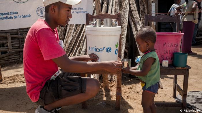A member of the NGO Action Contre la Faim gives drinking water to an infant during a malnutrition screening session in the Municipality of Ifotaka, in southern Madagascar A member of the NGO Action Contre la Faim gives drinking water to an infant during a malnutrition screening session in the Municipality of Ifotaka, in southern Madagascar