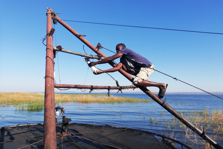 Takuchinchi Munsaka, from Muyobe village in Binga, makes final preparations before going fishing along the Zambezi River [Farai Matiashe/Al Jazeera]