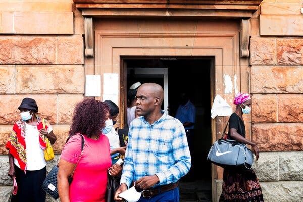 Jeffrey Moyo leaving the courtroom earlier this week in Bulawayo, Zimbabwe, with his wife, Purity, in pink dress.