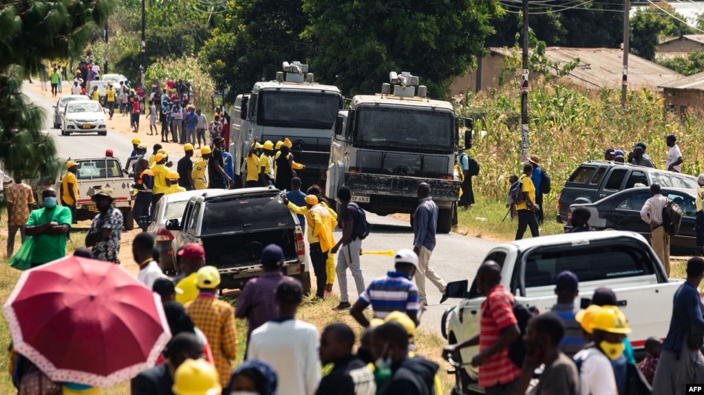 FILE - Zimbabwe police patrol outside the venue where Nelson Chamisa of the Citizens Coalition for Change was to speak in Marondera, March 12, 2022. In September, journalist Ruvimbo Muchenje was barred entry to a CCC event; another reporter was also barred and harassed.