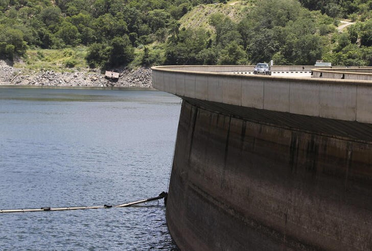 A motorist drives on top of the Kariba Dam wall in Kariba