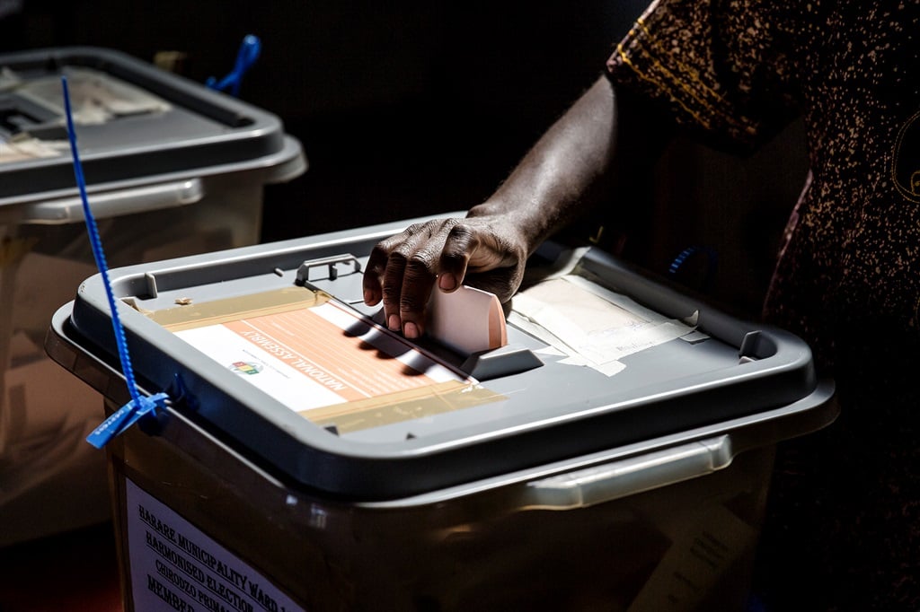 A man casts his ballot in a polling station located in the suburb of Mbare in Zimbabwe's capital Harare, on July 30, 2018.