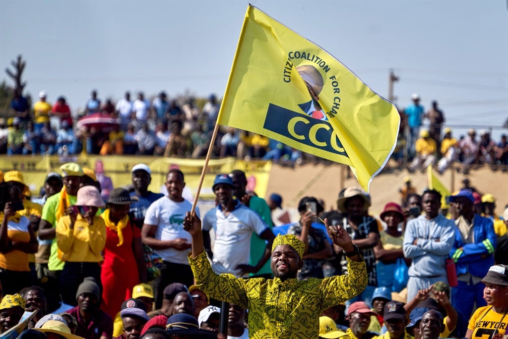 A Citizens Coalition for Change (CCC) rally in Bulawayo on 20 August 2023. BULAWAYO, ZIMBABWE - AUGUST 20: A man holds a flag