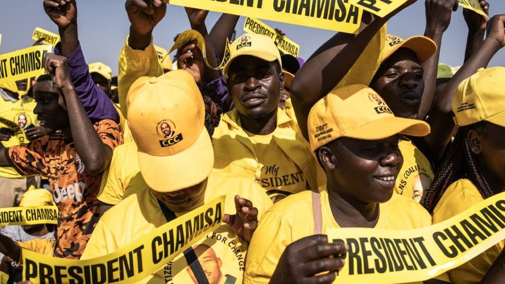 Supporters of the opposition leader for the Citizens Coalition for Change (CCC) Nelson Chamisa hold up banners with 'President Chamisa' on written on them during their final campaign rally in Harare. Supporters of the opposition leader for the Citize