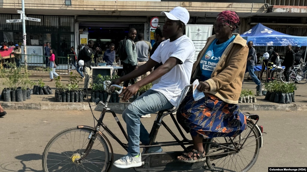 A family cycles in Harare on June 1, 2024.