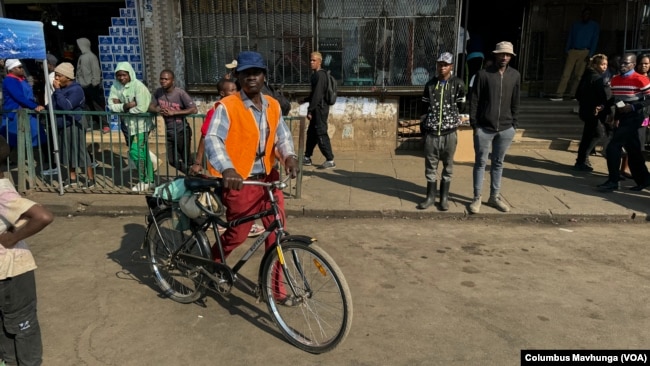 Ngoni Nyamadzawo, a part-time gardener in Harare’s affluent suburbs, cycles June 1, 2024. He bikes daily as a way to reduce costs to save his salary.