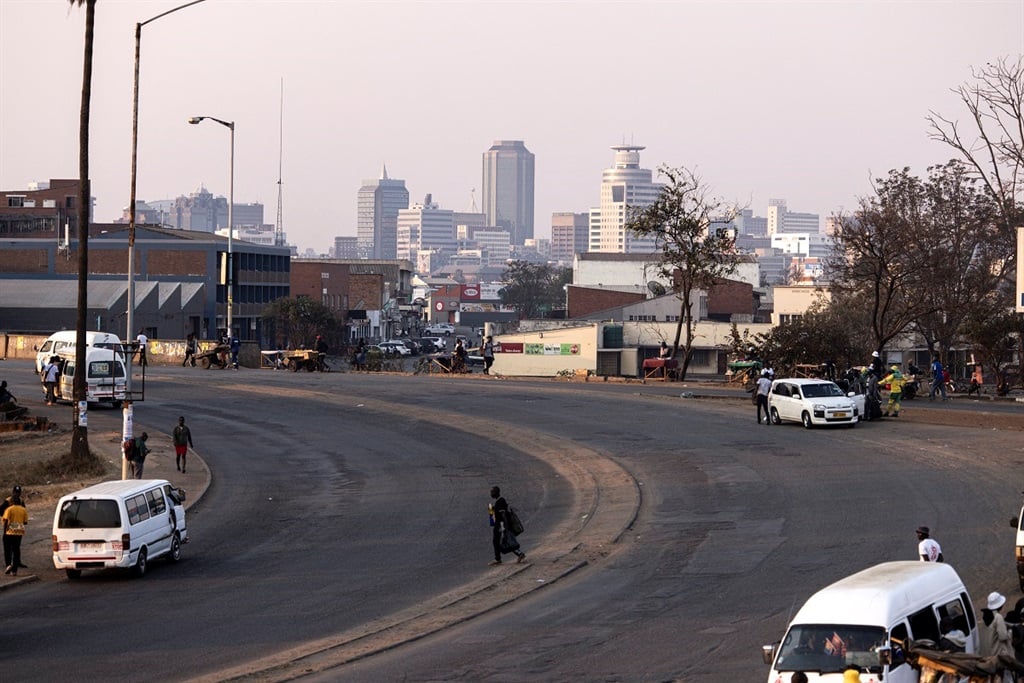 A man walks on a main road in Harare in August 2023. Zimbabwe is hosting the 44th ordinary SADC summit in Harare next month. (JOHN WESSELS / AFP)